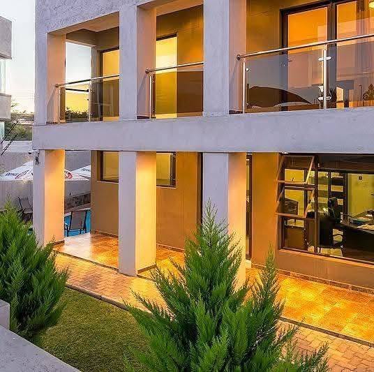 Modern building with glass balconies at sunset